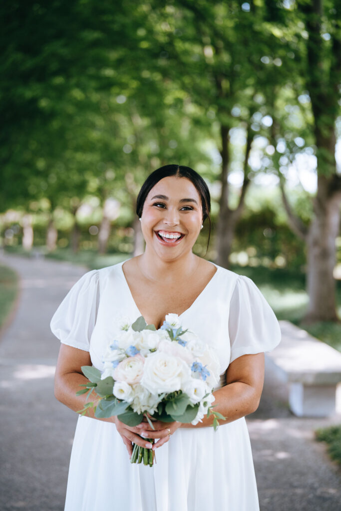 Bridal portrait of bride holding bouquet and smiling