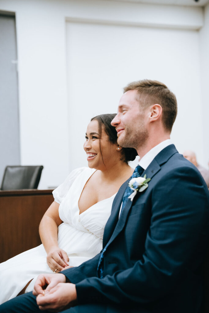 Bride and groom smiling while waiting for their turn