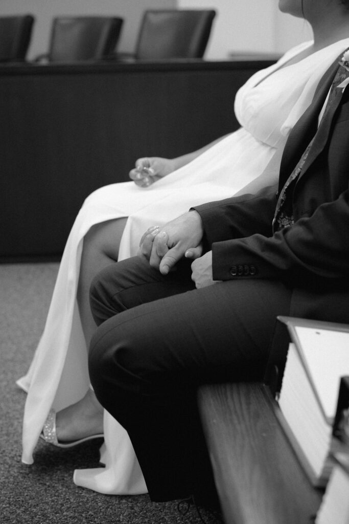 close up photo of couple holding hands while sitting down