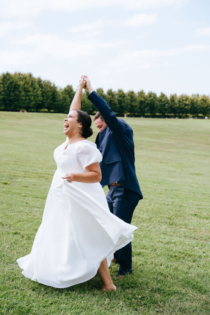 groom spinning bride around and bride laughing