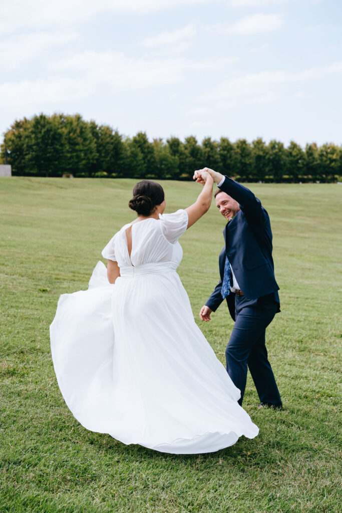 groom twirling bride at forest park