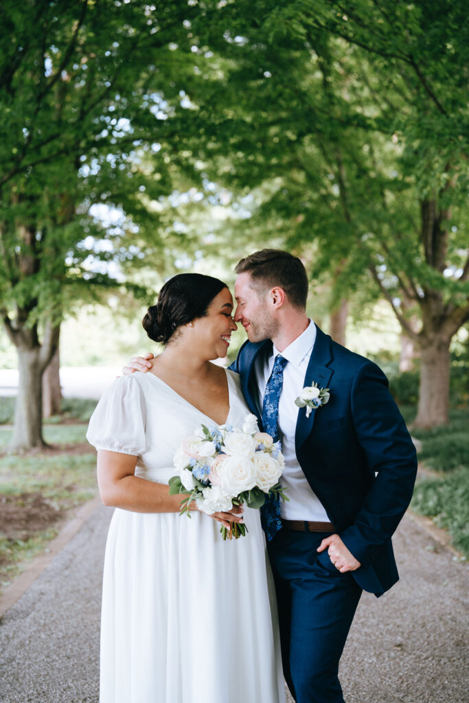 bride and groom nose kissing in forest park