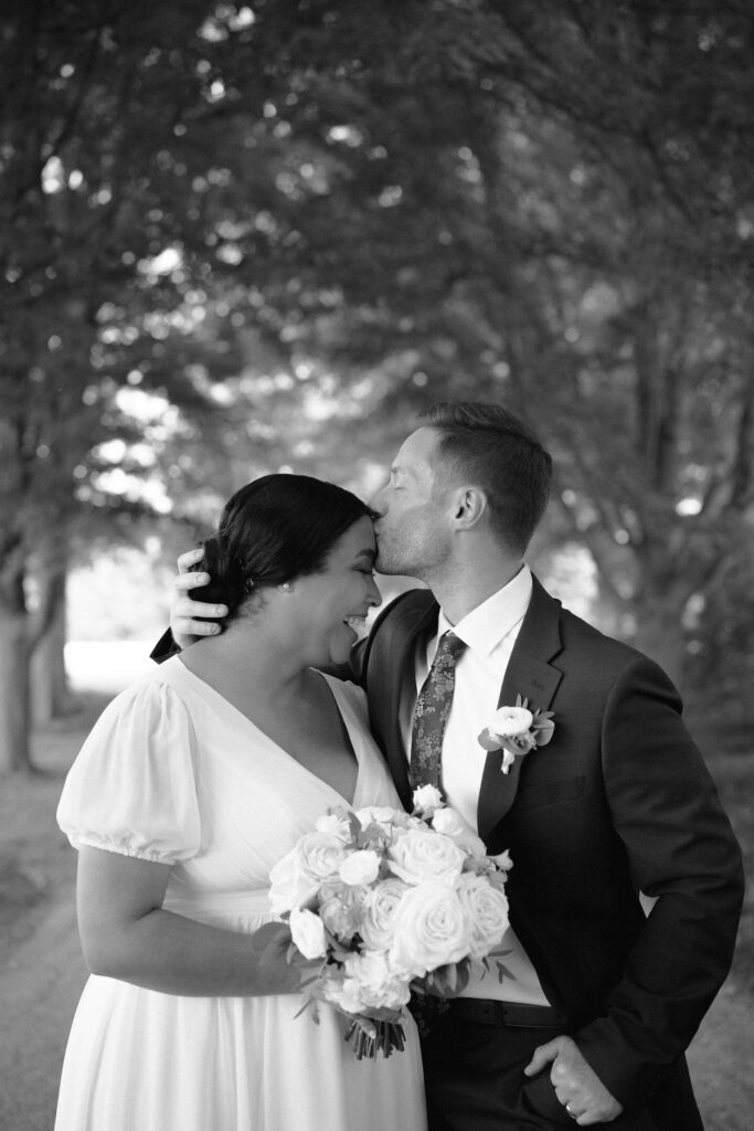 groom kissing bride on the forehead