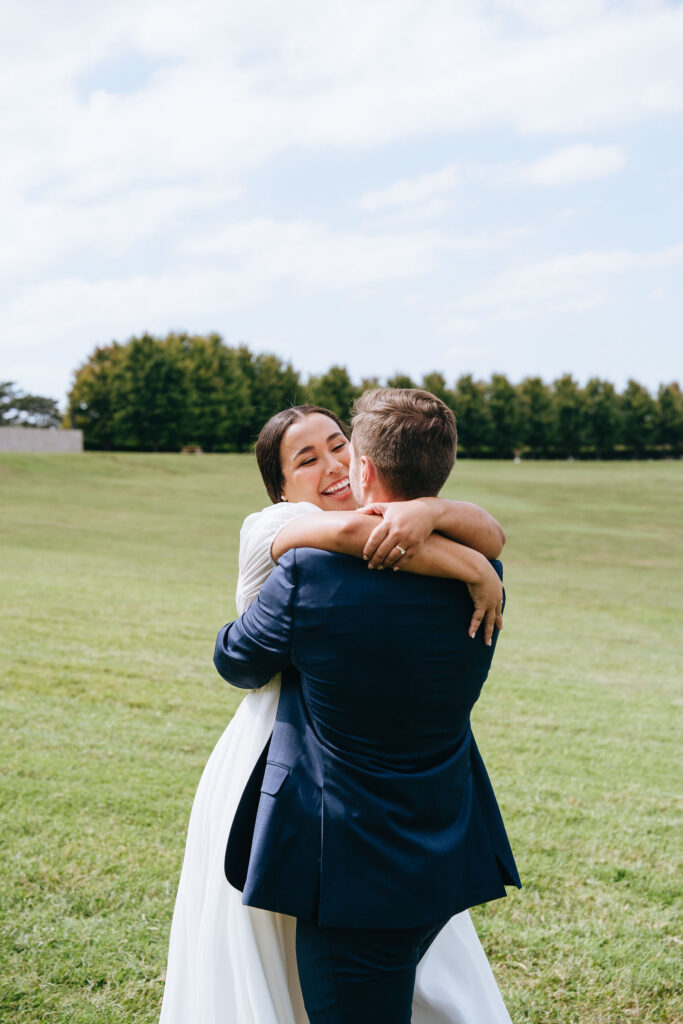 bride and groom embracing at forest park