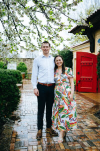 newly engaged couple standing side by side and smiling