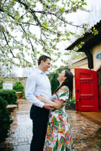 Newly engaged couple facing each other and smiling