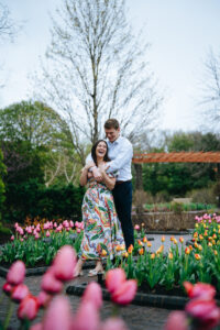 Man hugging fiance from behind while they both laugh