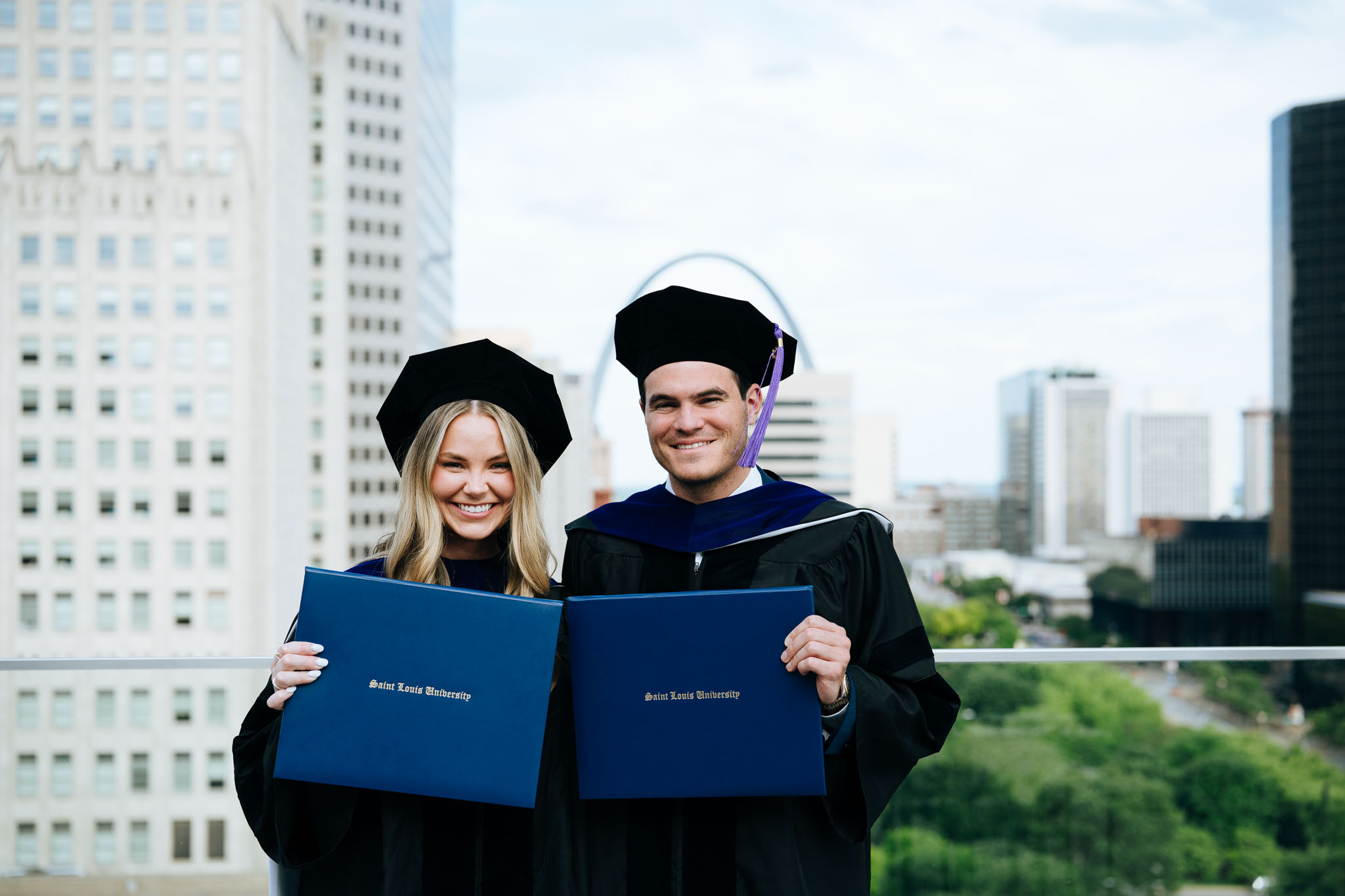slu law grads holding diplomas
