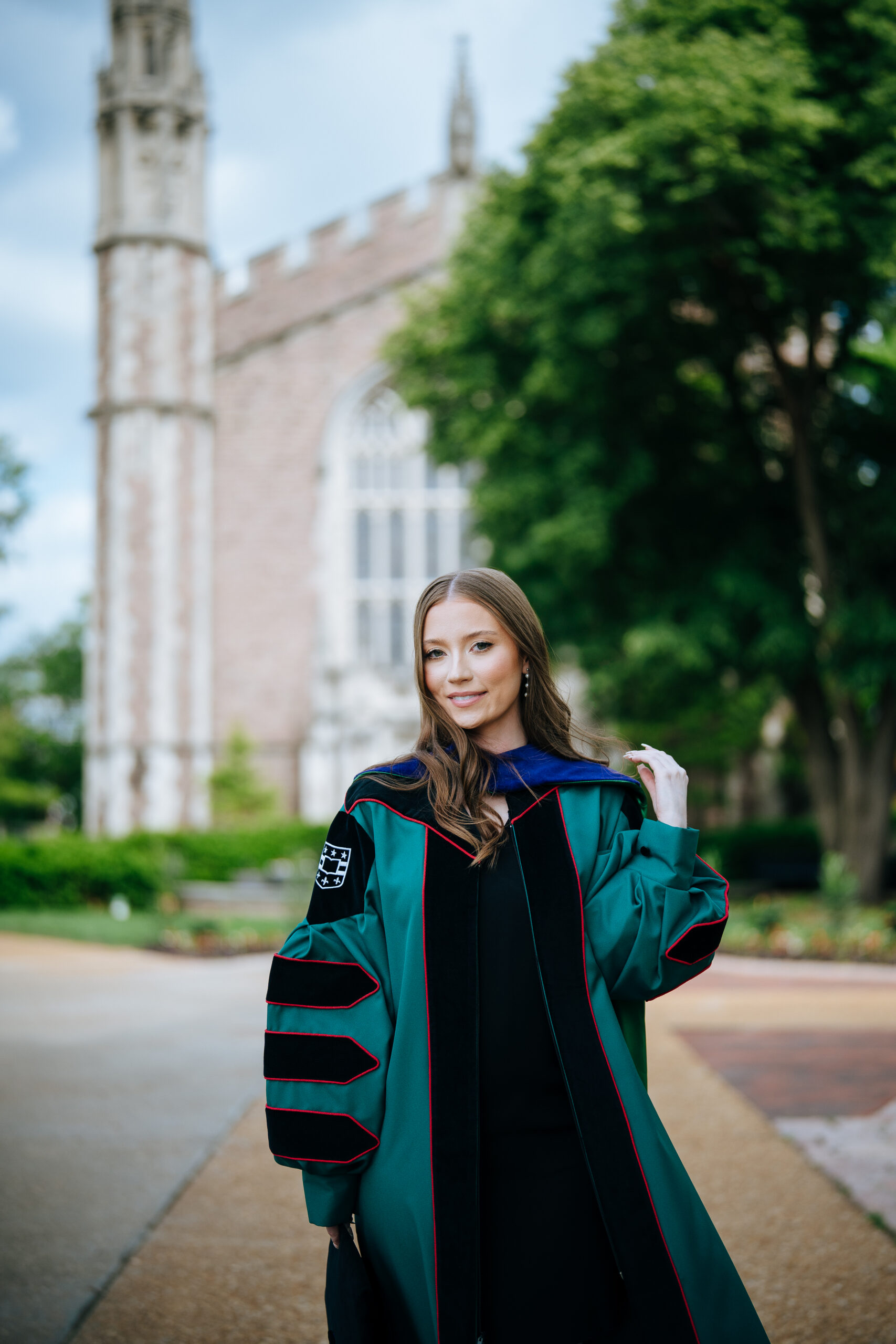 washu law grad stands in front of church on washu's campus